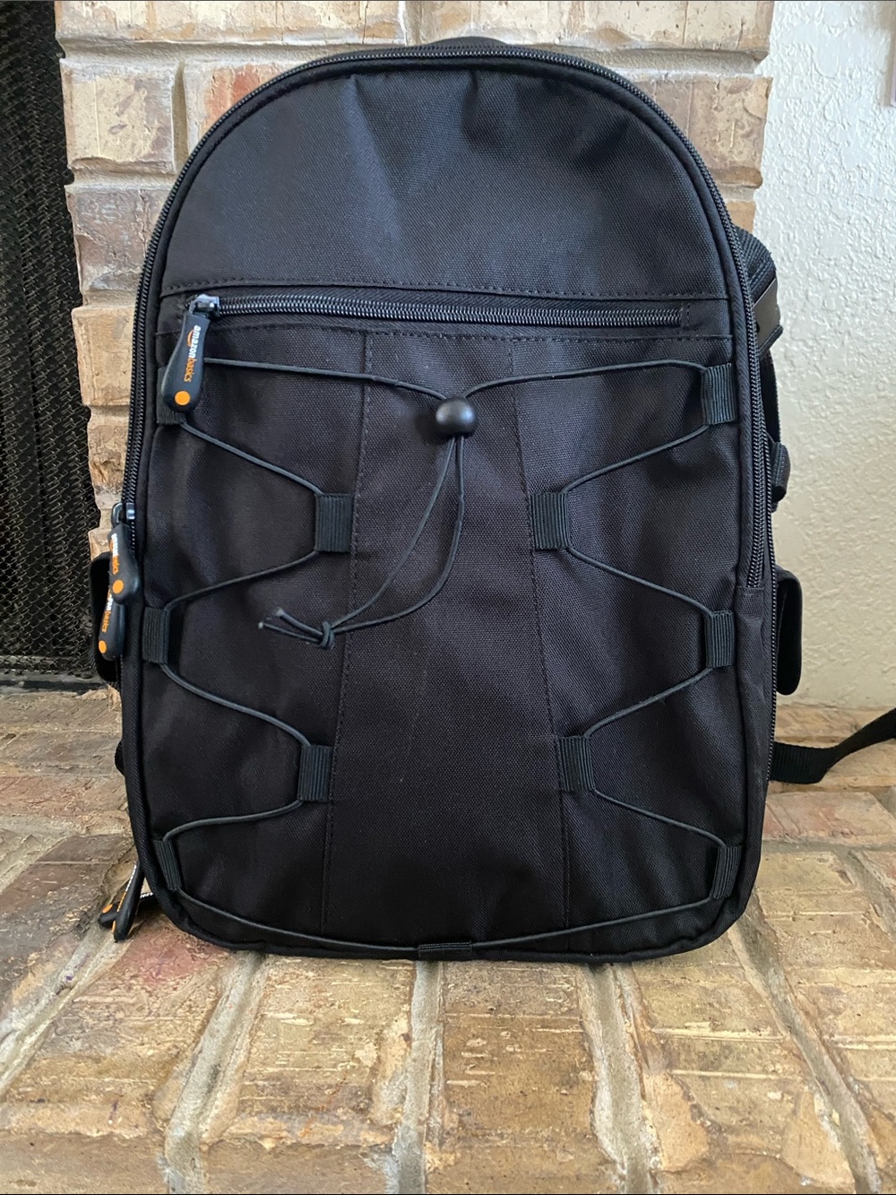 Compact Black Camera Backpack with Front Bungee
